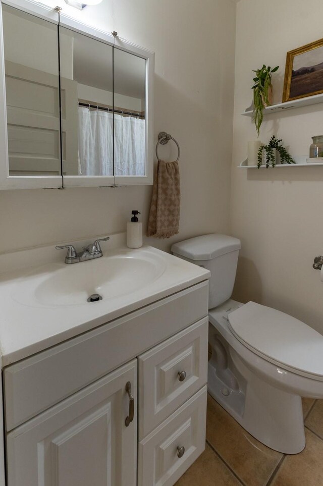 bathroom featuring tile patterned flooring and vanity