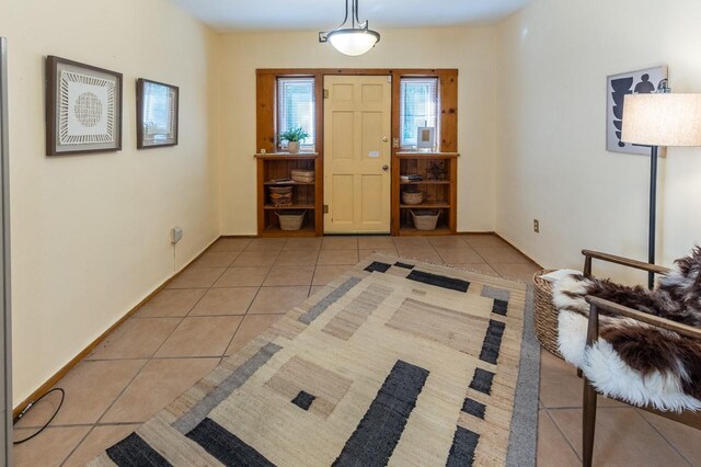 kitchen with light tile patterned floors, white appliances, and sink