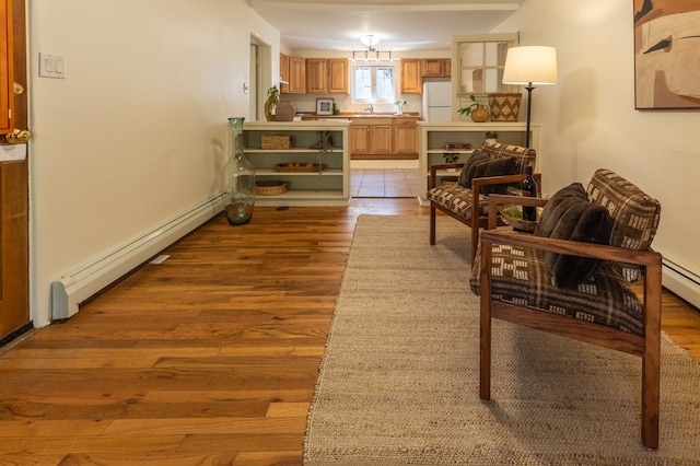 sitting room with light hardwood / wood-style floors and baseboard heating