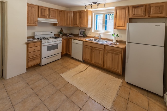 kitchen with sink, light tile patterned floors, and white appliances