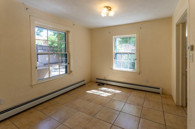 bathroom with a baseboard radiator, tile patterned floors, and shower / bathtub combination with curtain