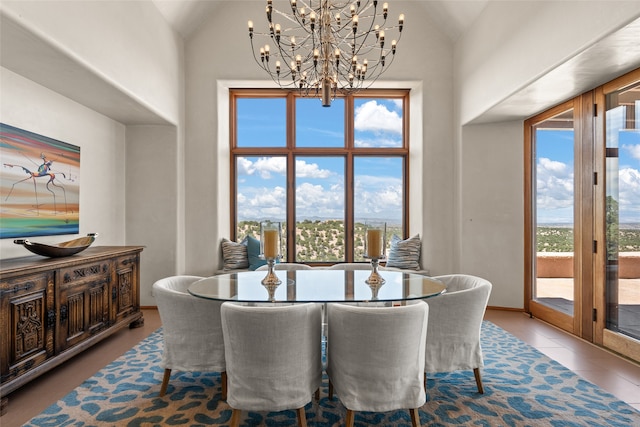 dining space with high vaulted ceiling and tile patterned floors