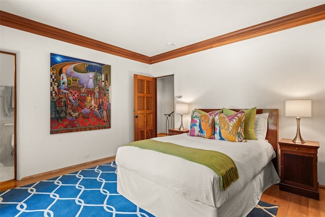 bedroom with crown molding and light hardwood / wood-style flooring