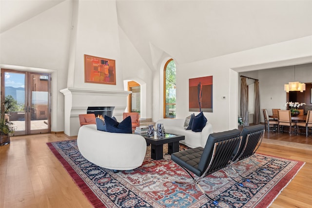 living room with hardwood / wood-style flooring and high vaulted ceiling