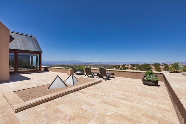 view of patio / terrace with a mountain view