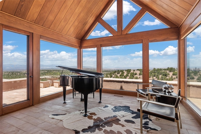 sunroom / solarium with lofted ceiling, a healthy amount of sunlight, and wood ceiling