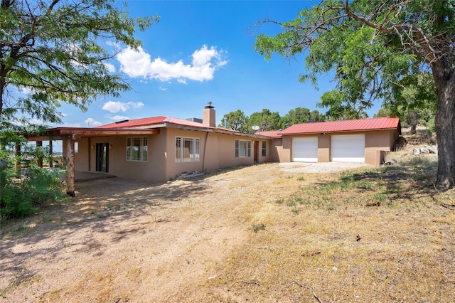 back of house featuring a garage