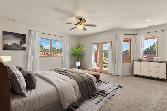 carpeted bedroom featuring ceiling fan, access to outside, and multiple windows