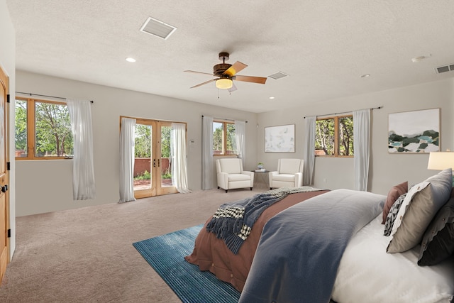 carpeted bedroom featuring access to exterior, ceiling fan, and a textured ceiling