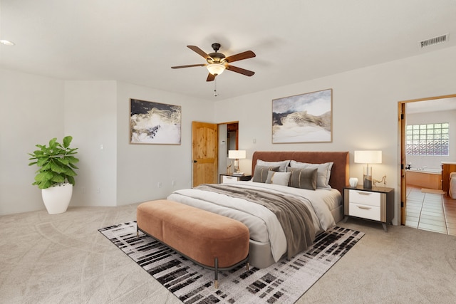 bedroom with carpet, ceiling fan, and connected bathroom