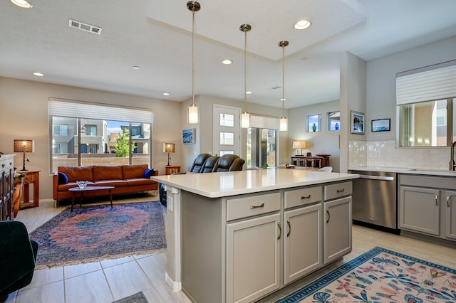 kitchen with visible vents, light tile patterned floors, dishwasher, open floor plan, and gray cabinetry