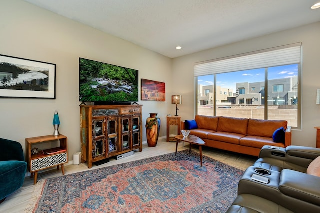 living area featuring wood finished floors, baseboards, and recessed lighting