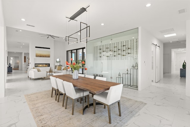 dining room featuring visible vents, recessed lighting, ceiling fan, a barn door, and marble finish floor