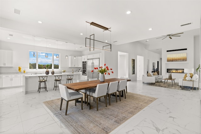 dining room featuring recessed lighting, visible vents, and marble finish floor