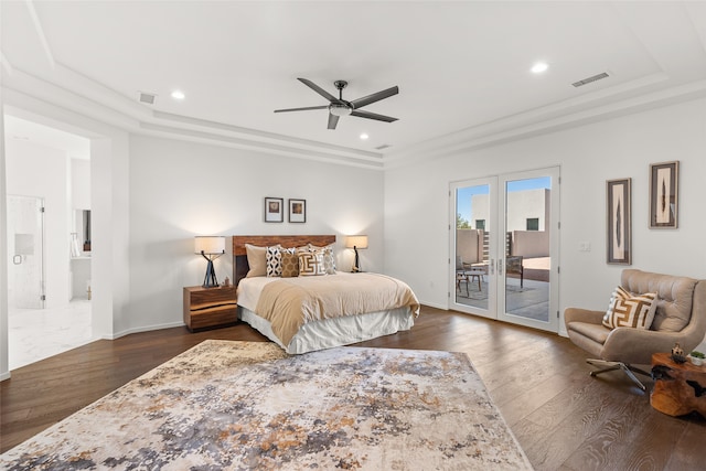 bedroom with access to exterior, visible vents, a tray ceiling, and dark wood-type flooring