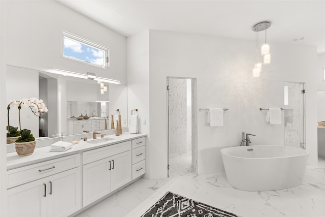 full bath featuring a freestanding bath, marble finish floor, vanity, and a walk in shower