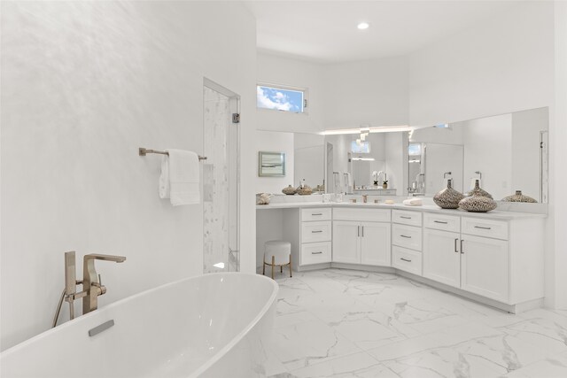 bathroom with dual vanity, a bathtub, and tile patterned flooring