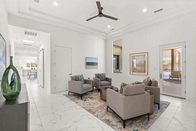 living area featuring visible vents, marble finish floor, and a ceiling fan