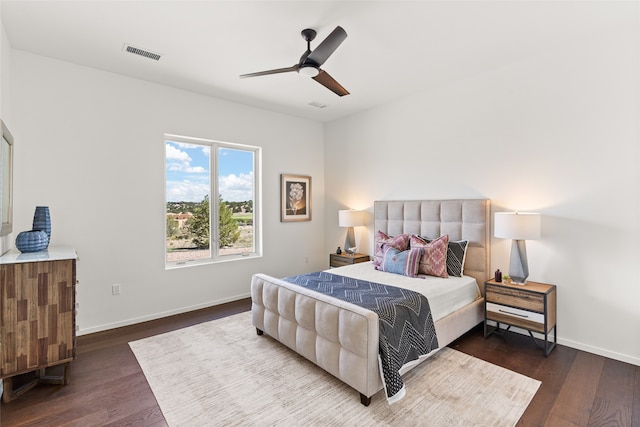 bedroom featuring dark wood-type flooring, baseboards, visible vents, and ceiling fan