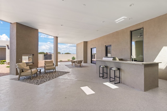 view of patio / terrace with outdoor dining space, outdoor wet bar, and fence