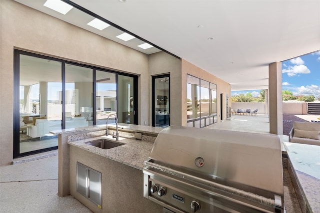 view of patio with a sink, grilling area, and an outdoor kitchen