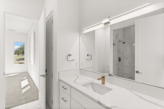 bathroom with vanity, marble finish floor, and a marble finish shower