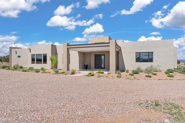 back of property with stucco siding