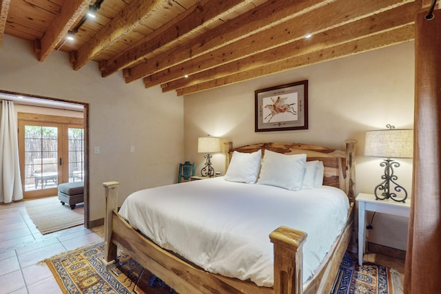 bedroom featuring beam ceiling, light tile patterned floors, and wood ceiling