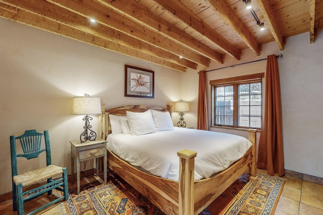 tiled bedroom with beam ceiling, rail lighting, and wooden ceiling