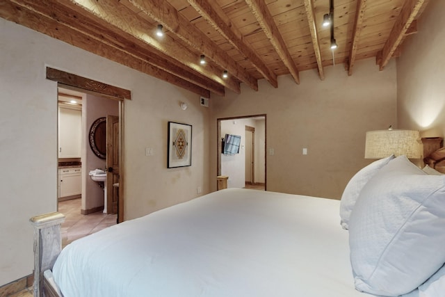 bedroom with beam ceiling, ensuite bathroom, and wooden ceiling