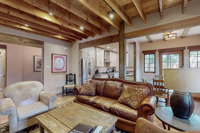 living room with beamed ceiling and light tile patterned floors