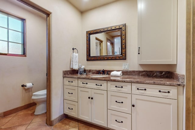 bathroom featuring tile patterned flooring, vanity, and toilet