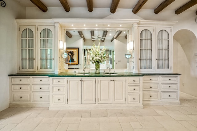 bathroom with tile flooring, ceiling fan, lofted ceiling with beams, and vanity