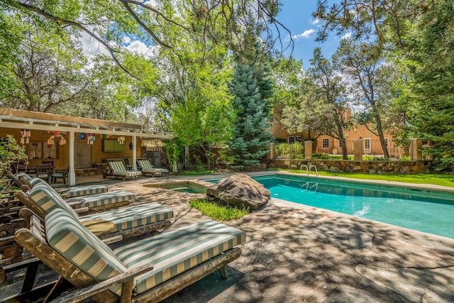 view of swimming pool with a patio and an in ground hot tub