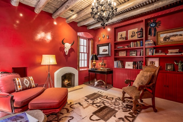 sitting room featuring beamed ceiling, carpet, and a chandelier