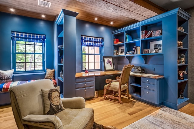 home office with wooden ceiling, built in desk, and light hardwood / wood-style flooring