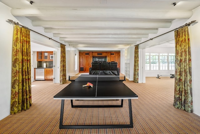 playroom featuring carpet flooring and beamed ceiling