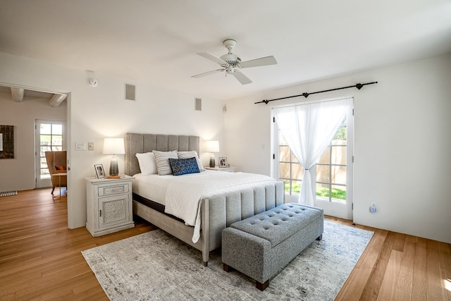 bedroom featuring hardwood / wood-style floors, ceiling fan, and access to outside