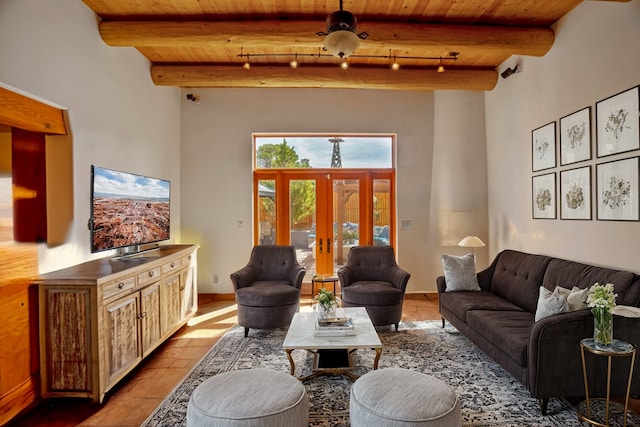 living room featuring wood ceiling, beamed ceiling, rail lighting, light tile patterned floors, and french doors