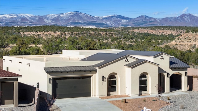 view of front of house with a mountain view and a garage