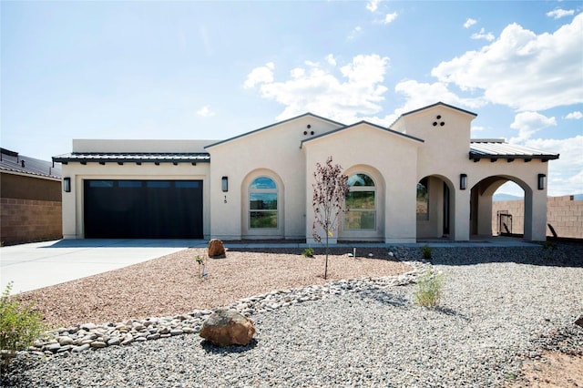 mediterranean / spanish-style home featuring a garage