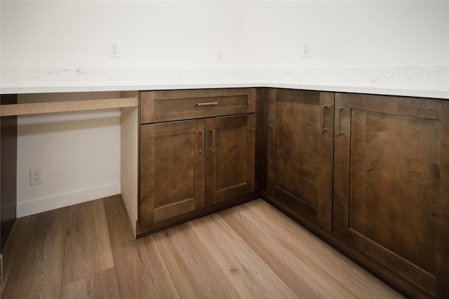 interior details featuring hardwood / wood-style floors and built in desk