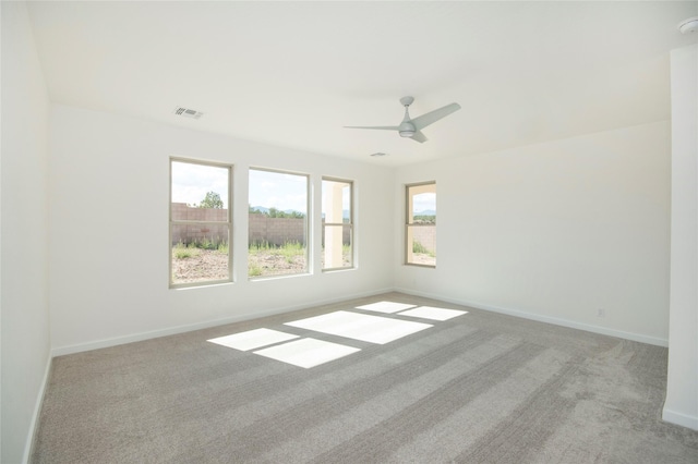 empty room featuring light colored carpet and ceiling fan