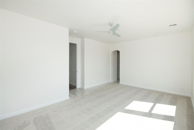 empty room featuring light colored carpet and ceiling fan