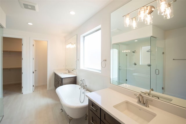 bathroom with vanity and independent shower and bath