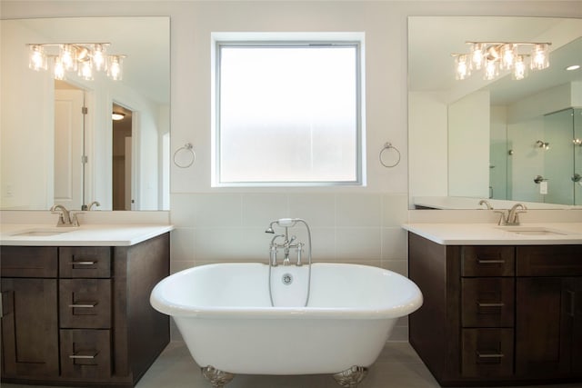 bathroom with a tub to relax in, a healthy amount of sunlight, and tile walls