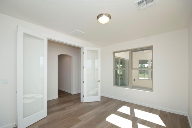 unfurnished room with wood-type flooring