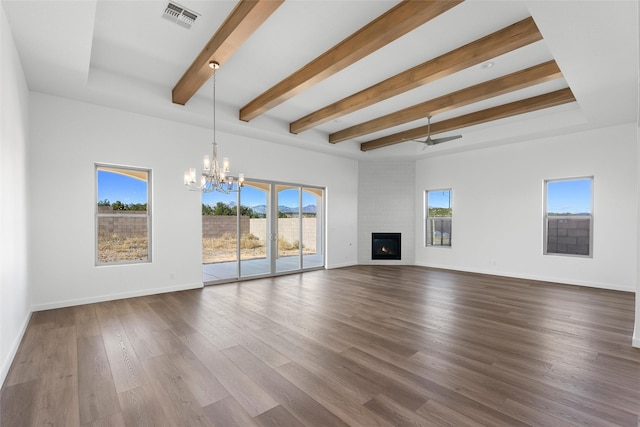 unfurnished living room with wood-type flooring, a large fireplace, and a wealth of natural light