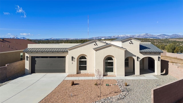 view of front of property with a mountain view and a garage