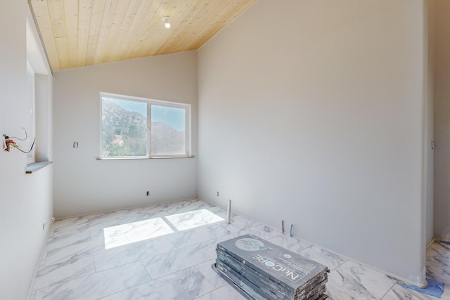 spare room featuring lofted ceiling and wood ceiling